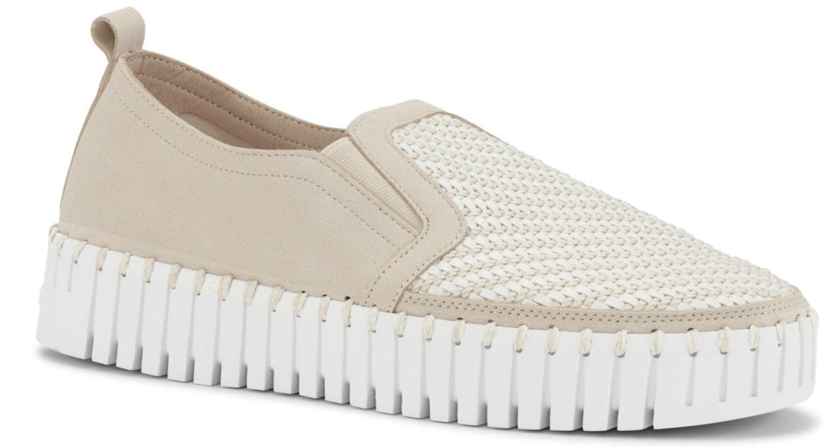 Beige slip-on shoe with a white ribbed platform sole and woven design on the upper.