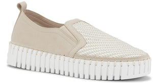 Beige slip-on shoe with a white ribbed platform sole and woven design on the upper.