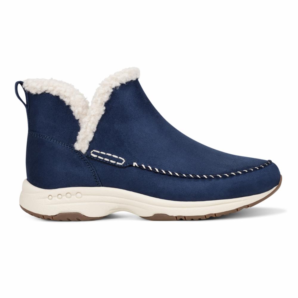 Navy blue ankle boot with white faux fur lining, off-white sole, and brown tread.