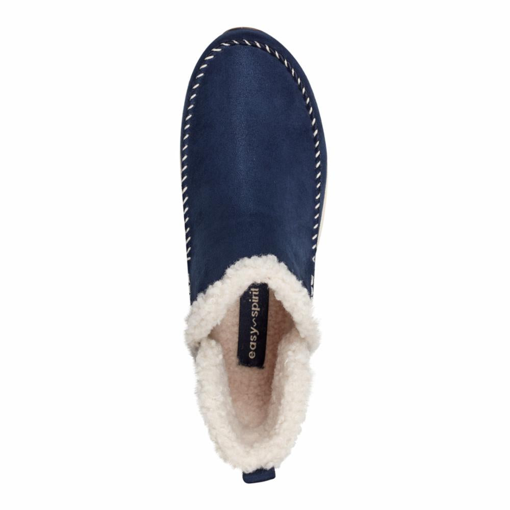 Navy blue slipper with white sherpa lining and white stitching around the upper edge, "easy spirit" label inside.