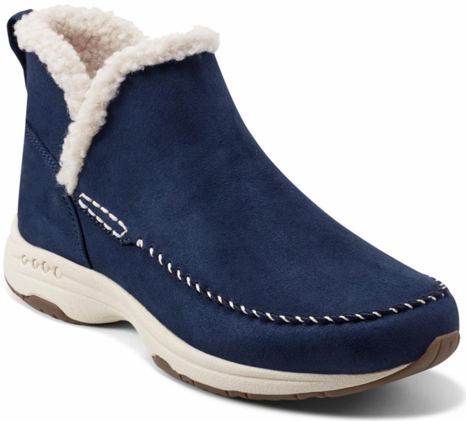 Navy blue ankle boot with faux fur lining and white stitching.