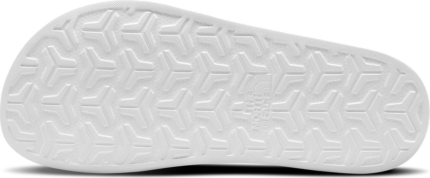 Sole of a white sandal with textured geometric pattern.