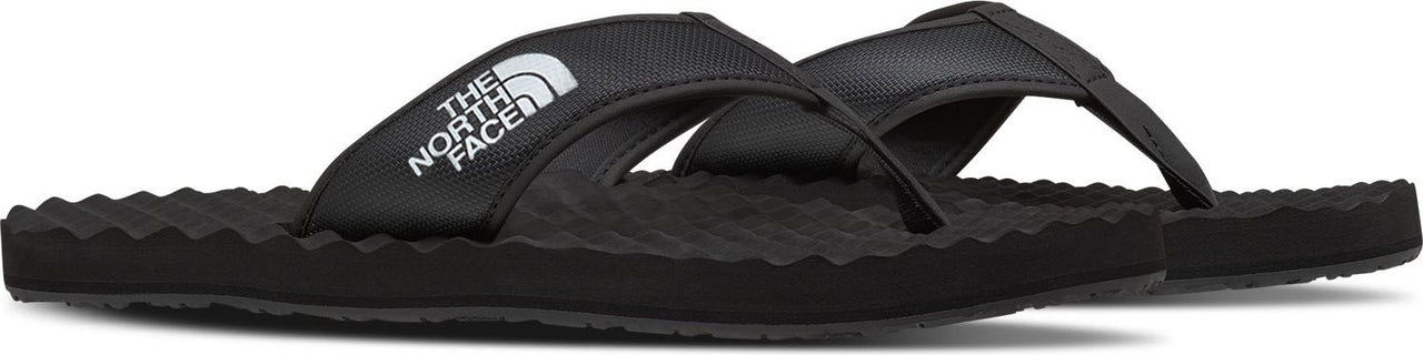 Black flip-flops with white "THE NORTH FACE" logo on the strap.
