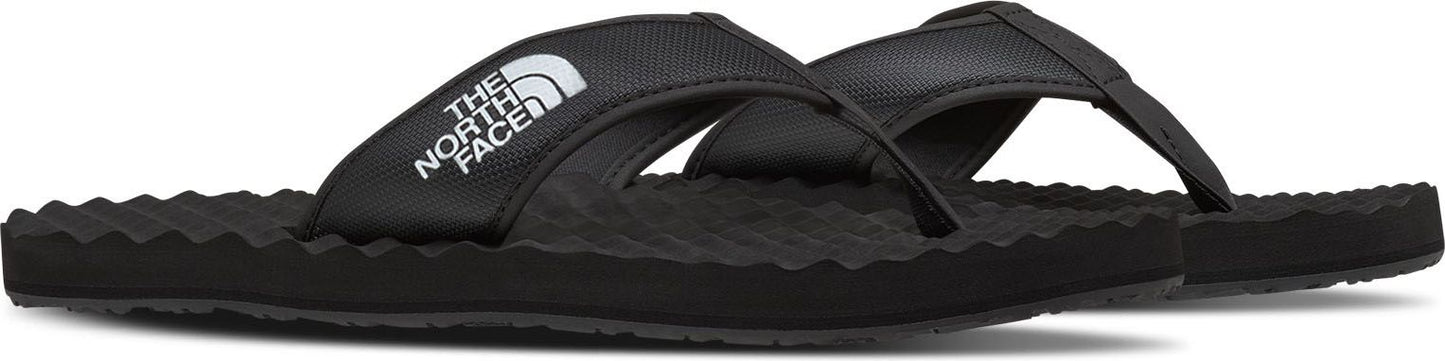 Black flip-flops with white "THE NORTH FACE" logo on the strap.