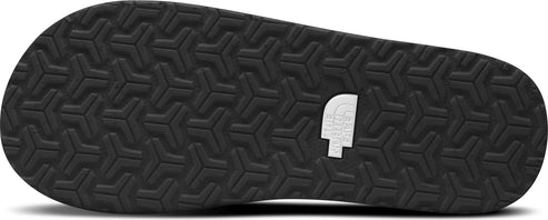 A black sandal sole with a repeating Y-shaped pattern, and a white logo.