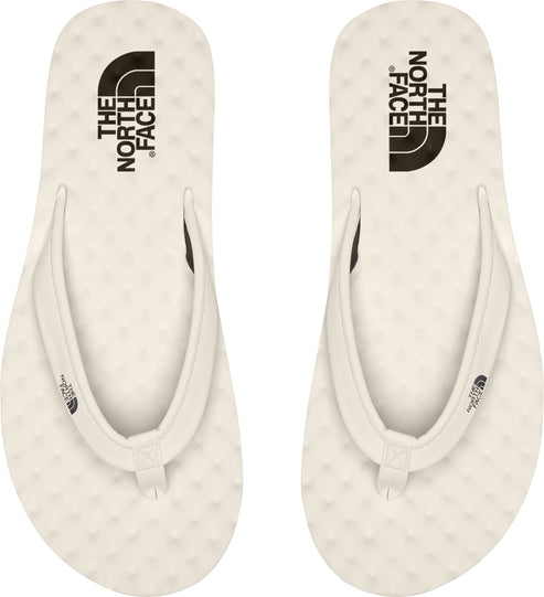 Two off-white flip-flops with the text "THE NORTH FACE" printed on each.