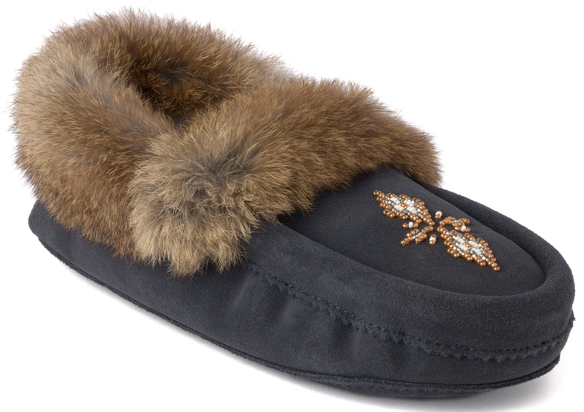 A black suede moccasin-style slipper featuring a plush brown fur trim around the opening and a decorative floral bead design on the top toe area.