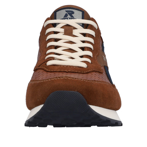 Front view of a brown sneaker with white laces and a navy blue accent.