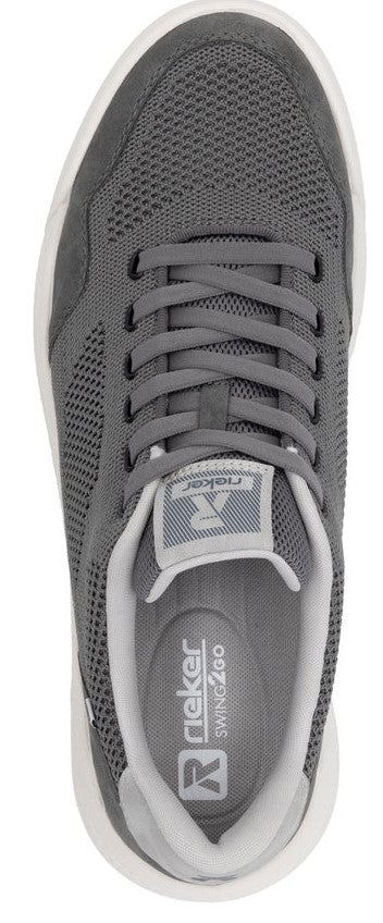 A top-down view of a gray sneaker with white soles and visible laces, with a logo on the tongue.