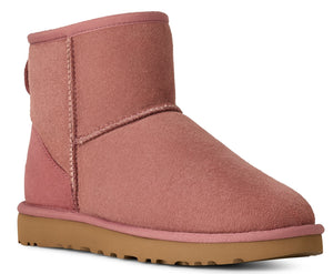 Ankle-high pink suede boot with a brown sole.