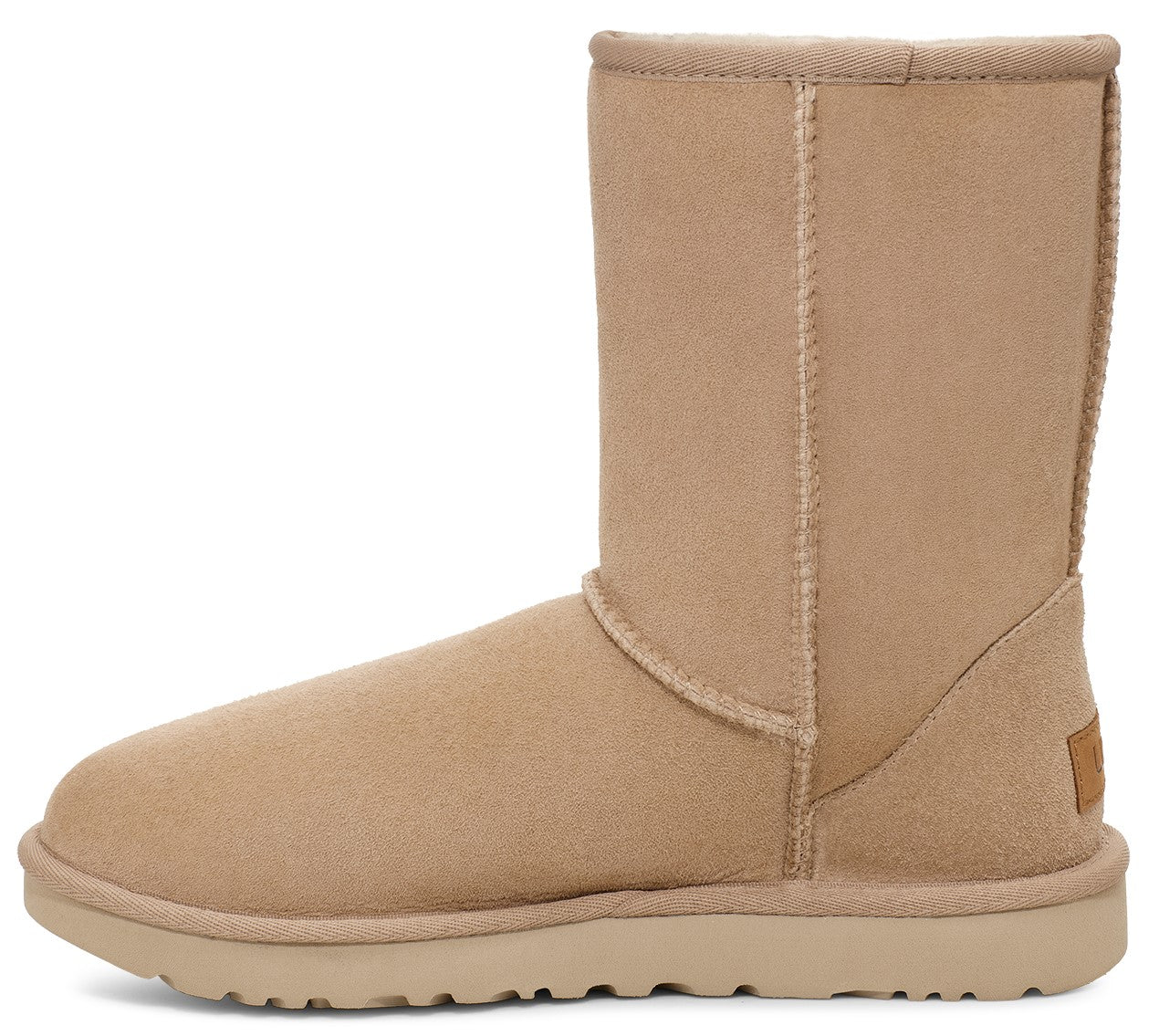 Beige suede UGG boot with a short shaft and a flat sole.