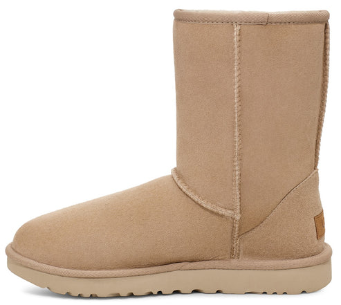 Beige suede UGG boot with a short shaft and a flat sole.