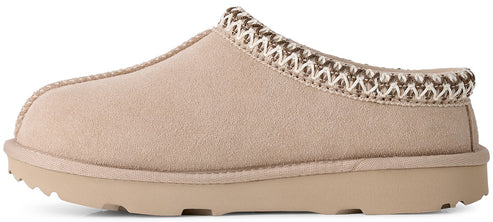 A beige suede slip-on mule slipper with a thick rubber sole and a decorative braided trim around the collar.