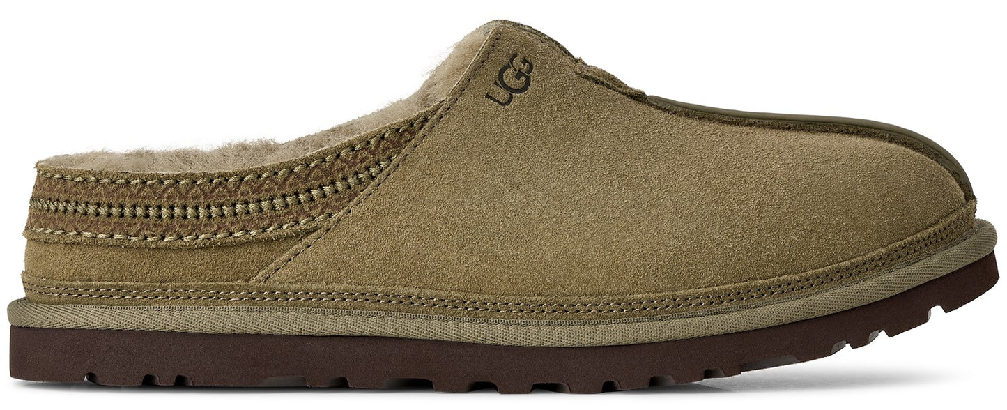 A tan suede slip-on slipper with a brown rubber sole, lined with tan faux fur and featuring a decorative woven pattern along the collar and the embossed brand logo on the upper side.