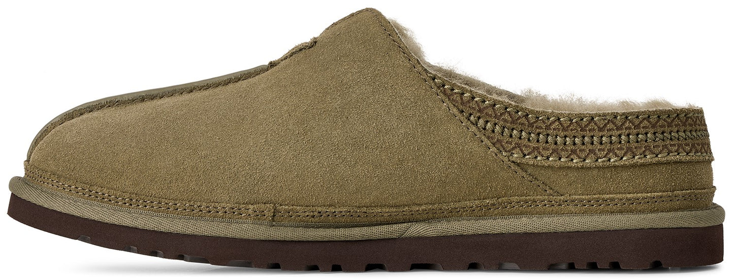 A slip-on slipper in olive-green suede with a brown rubber sole, featuring a fuzzy lining and a decorative braided pattern along the collar.