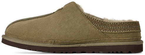 A slip-on slipper in olive-green suede with a brown rubber sole, featuring a fuzzy lining and a decorative braided pattern along the collar.