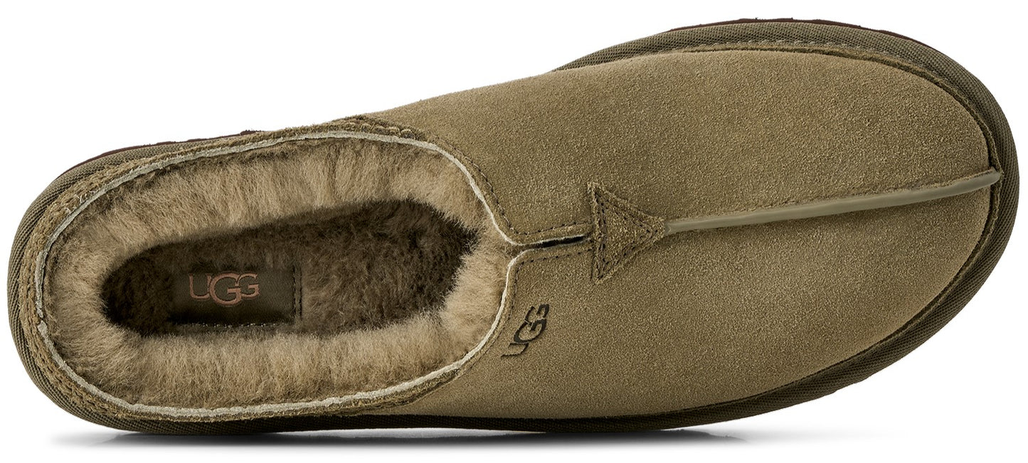 A top-down view of an olive green suede slip-on slipper with a plush tan sheepskin lining, featuring a UGG brand logo patch inside the heel and a small UGG logo embossed on the side near the collar.