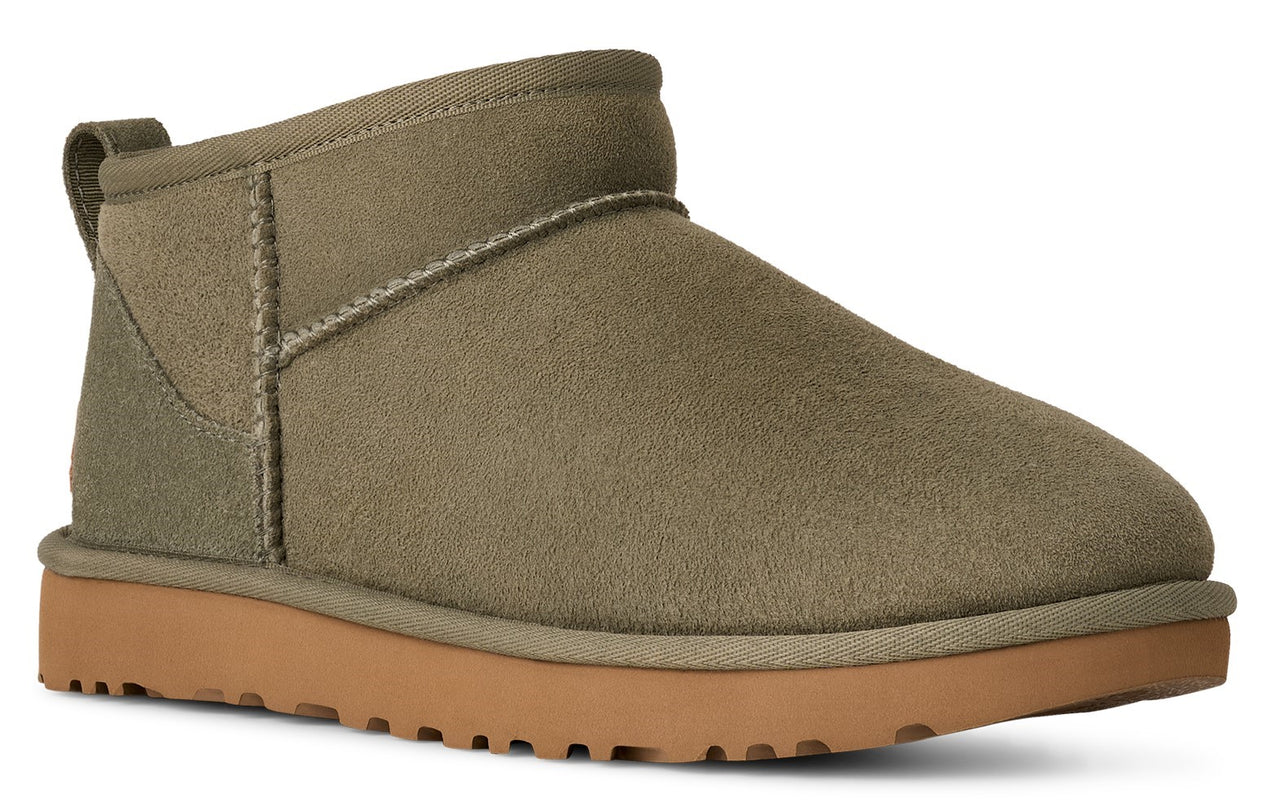 Ankle-high suede boot with a low, treaded platform sole, and a pull tab on the back.