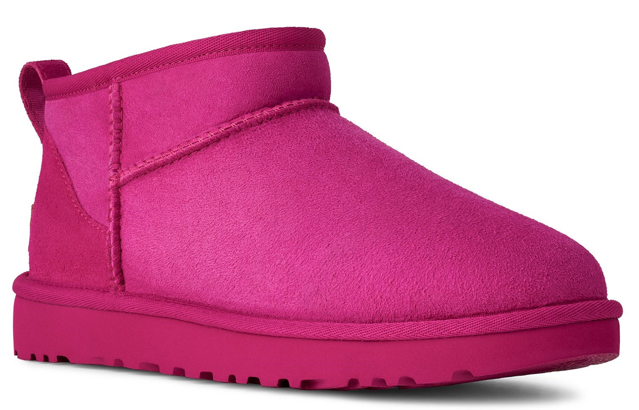 Hot pink ankle boot with a round toe and a loop at the back of the ankle.