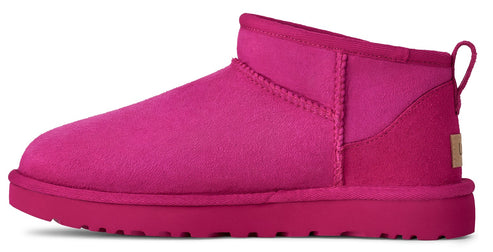 A pink, ankle-high UGG boot.
