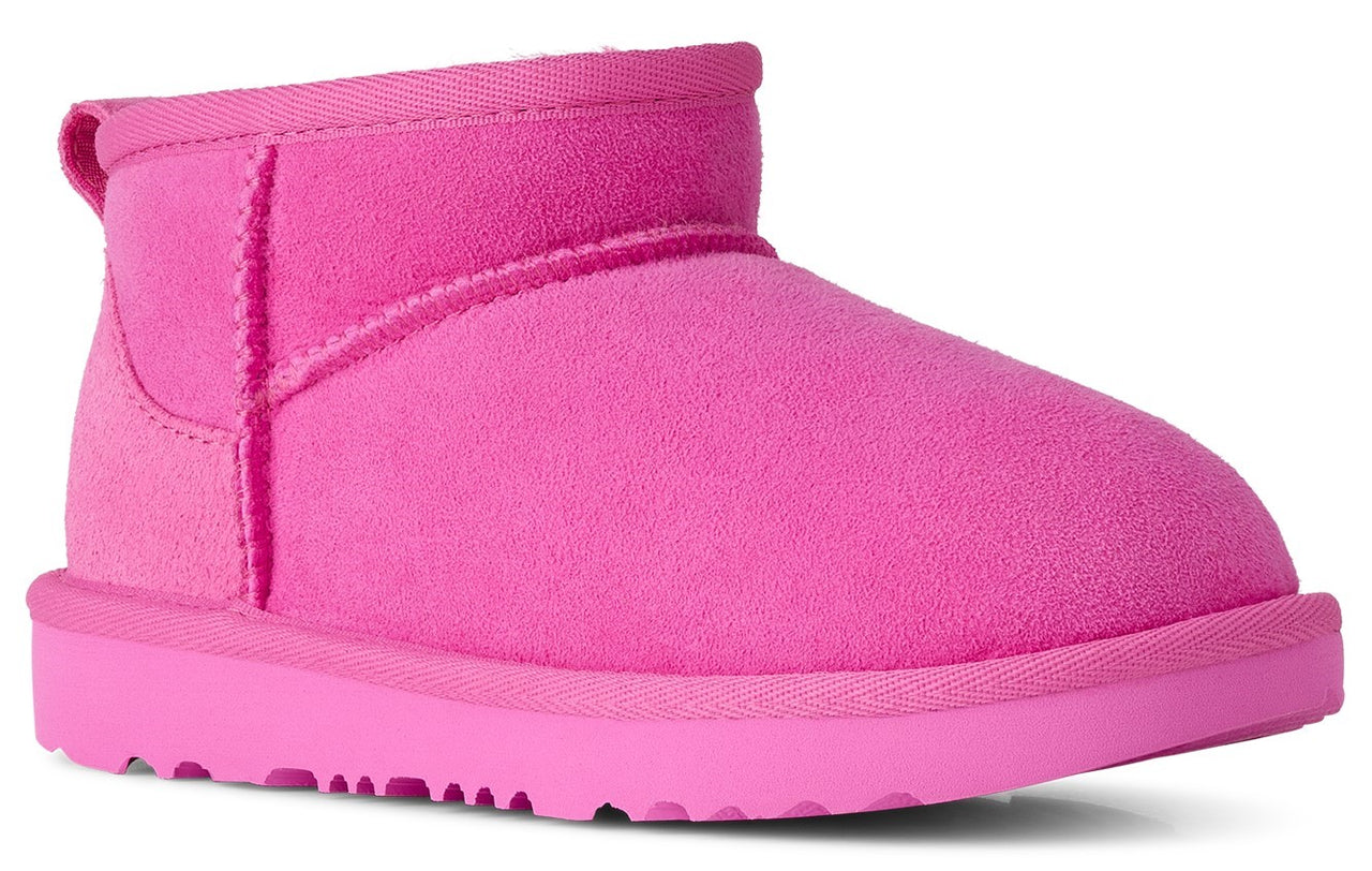 A hot pink suede ankle boot with a rounded toe and a thick matching rubber sole.