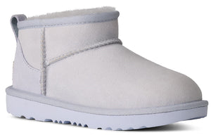 A short white suede boot with a white sole.