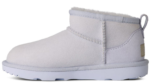 Ankle-high, white sheepskin boot with white soles and heel loop.