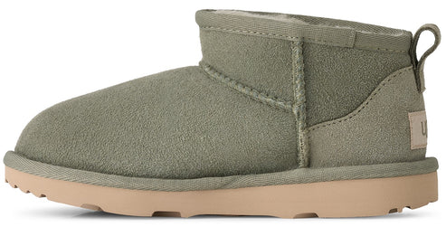 A low-cut suede ankle boot in olive green with a light tan rubber sole, showing a pull tab on the back and a visible brand tag on the heel.