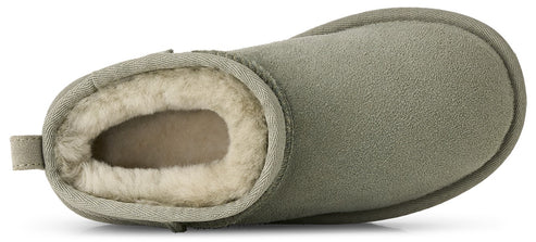 A top-down view of an olive green suede bootie lined with thick, cream-colored shearling, featuring a pull tab at the heel and a rounded toe.