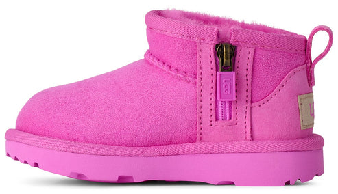 A side view of a bright pink suede ankle boot with a zipper on the side featuring a pull tab labeled UGG, a thick rubber sole, and a pull loop at the heel.