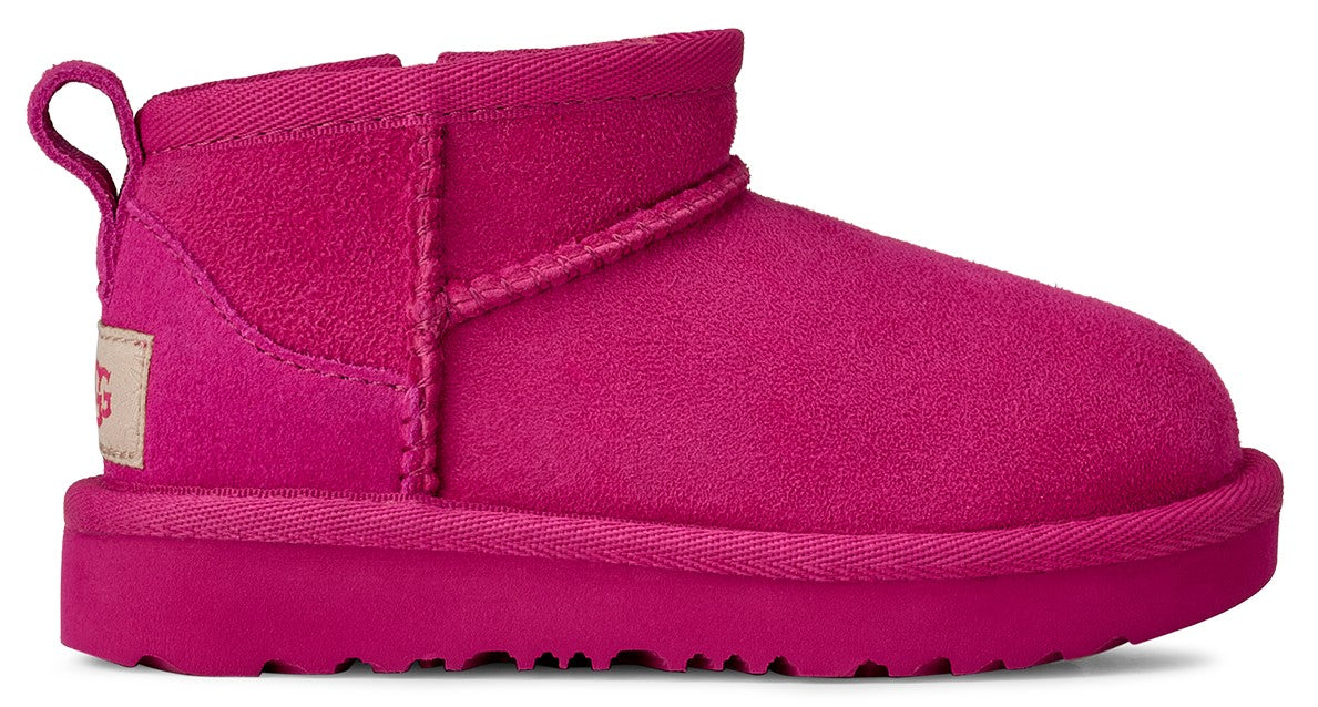 Close-up of a short, vibrant pink suede boot with a loop on the back.