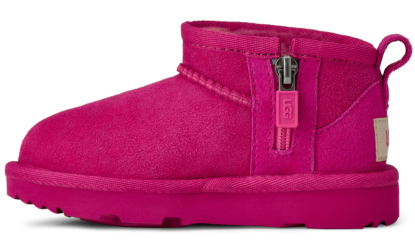 Hot pink, suede UGG boot with a zipper on the side and loop on the back