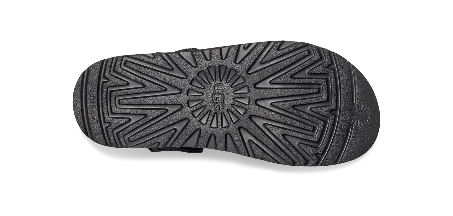 A sole of a shoe in black with a unique starburst design.
