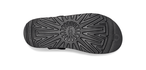 A sole of a shoe in black with a unique starburst design.