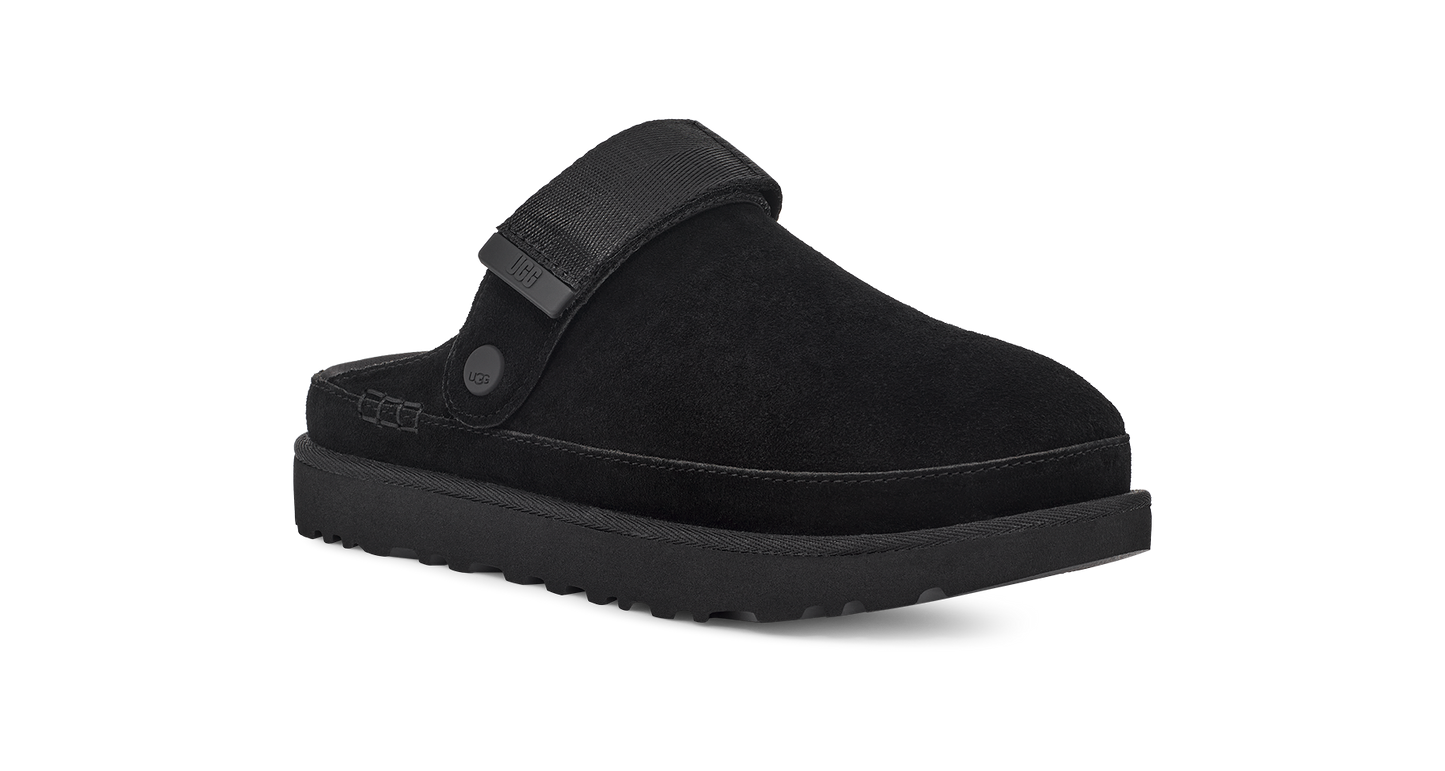 Black slip-on shoe with a thick sole and a strap.