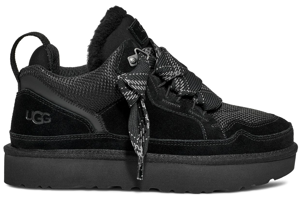 Black UGG shoe featuring a platform sole, black laces with a black and gray pattern, and a suede heel with UGG logo.
