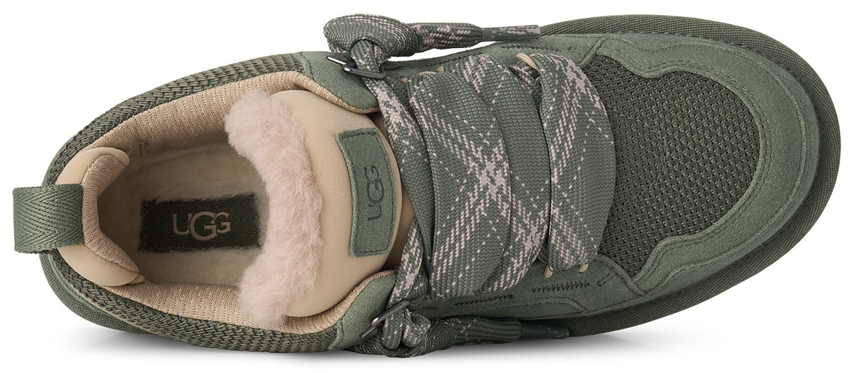 An olive green sneaker from a top-down perspective, featuring thick patterned laces, a beige plush lining around the collar, and an UGG logo patch on the tongue and inner sole.