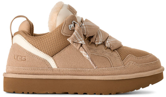 A tan UGG shoe with ribbon laces and a thick brown sole.