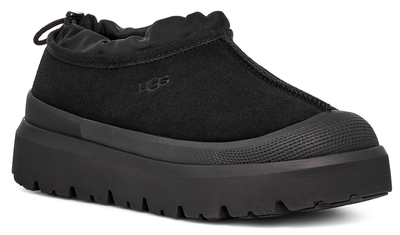 Black slip-on platform sneaker with a rounded toe.