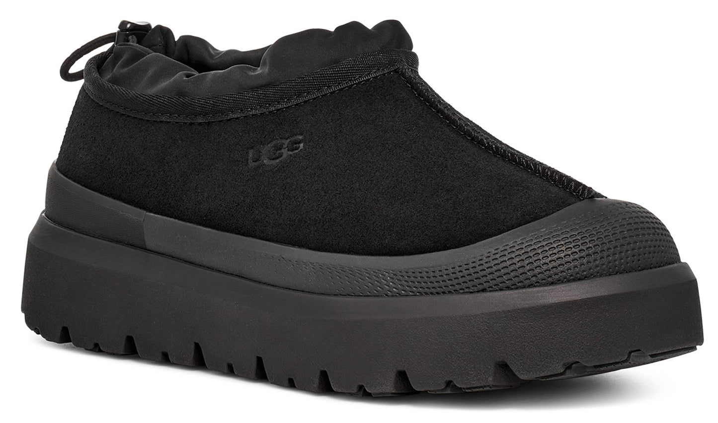 Black slip-on platform sneaker with a rounded toe.