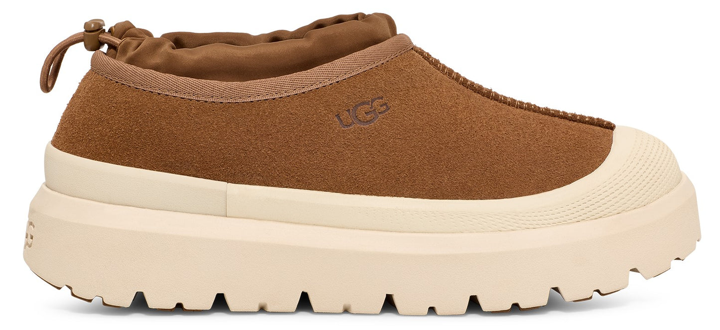 Brown UGG shoe with a thick, cream-colored sole and a rounded toe.