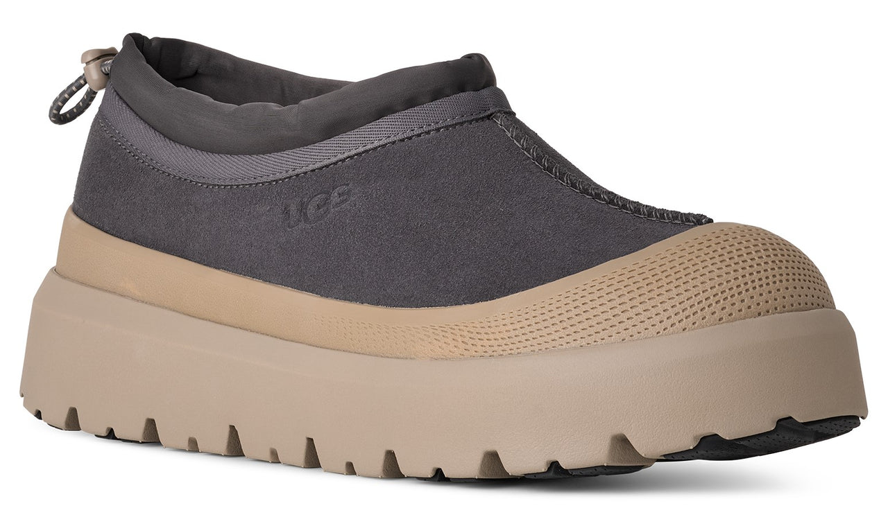 Ankle-height grey slip-on shoe with a tan sole.