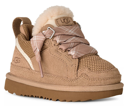 Child's light brown sneaker with tan sole, fluffy cream trim, patterned ribbon laces, and UGG logo on the side and tongue.