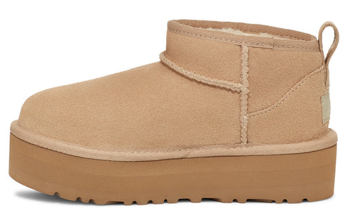 Tan suede ankle boot with platform sole and heel pull tab.