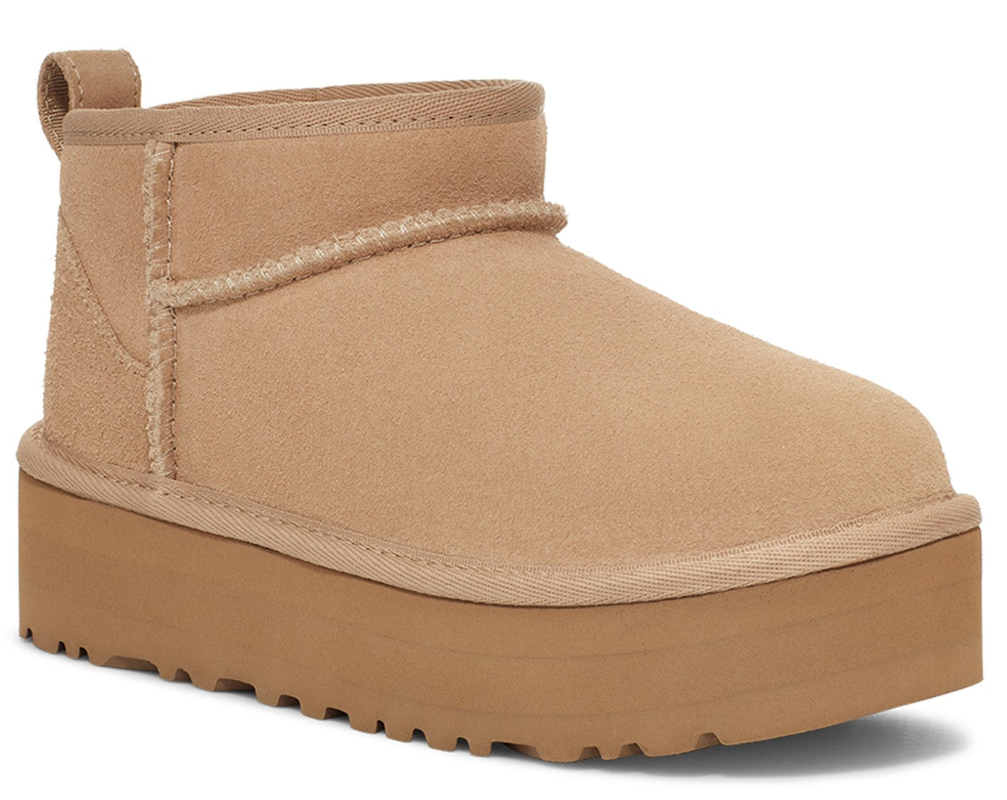 Tan ankle height boot with thick platform sole and pull tab.