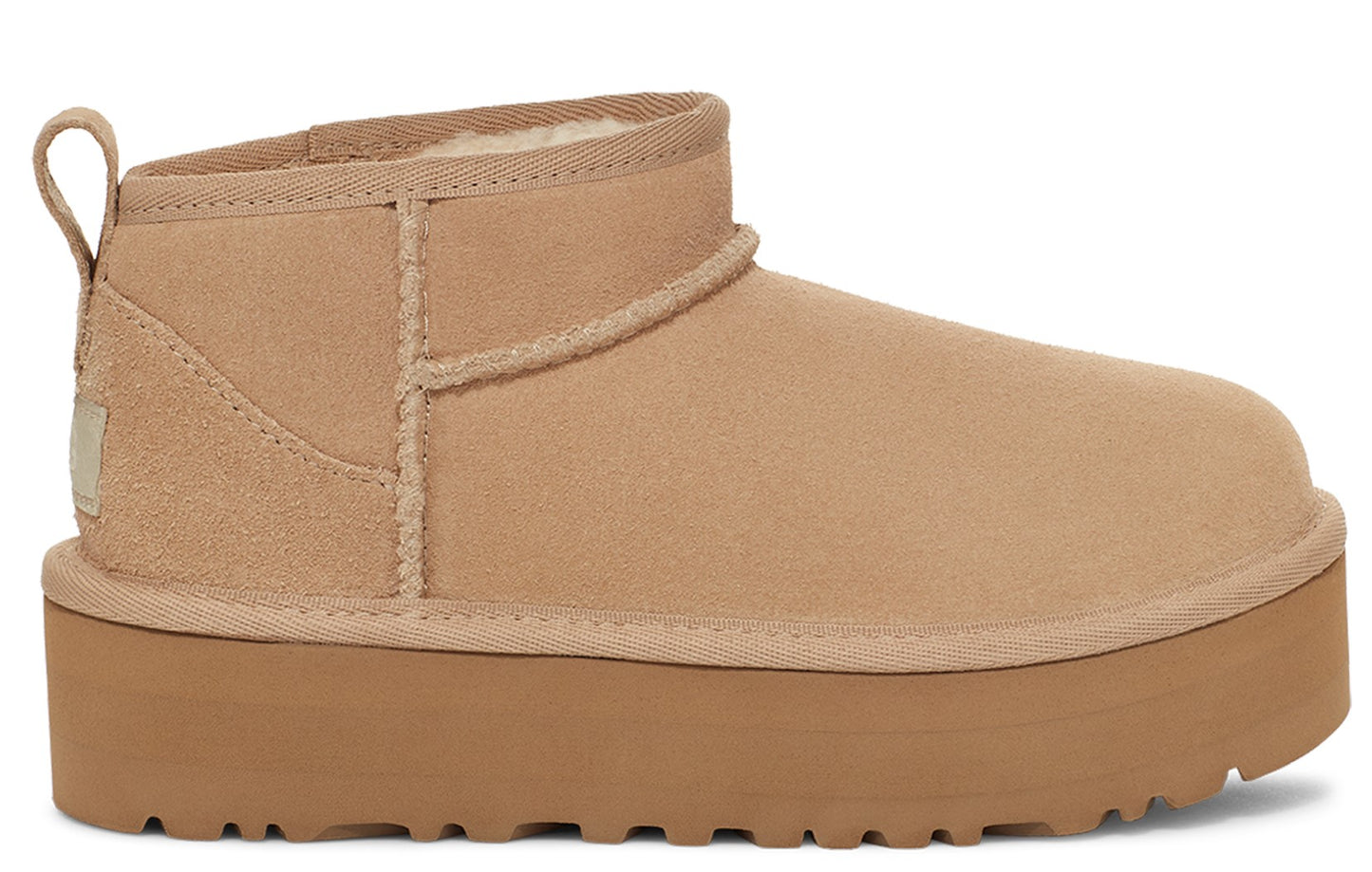 Tan short UGG boot with a thick platform sole.