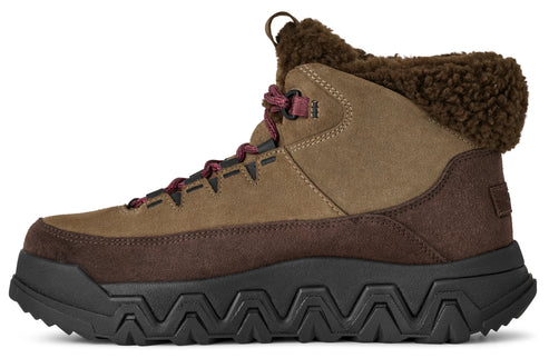 A brown leather hiking boot with a black sole and a fur lining.