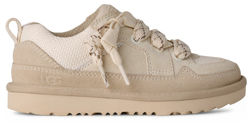 An UGG sneaker with beige uppers, off-white laces and a looped heel pull.