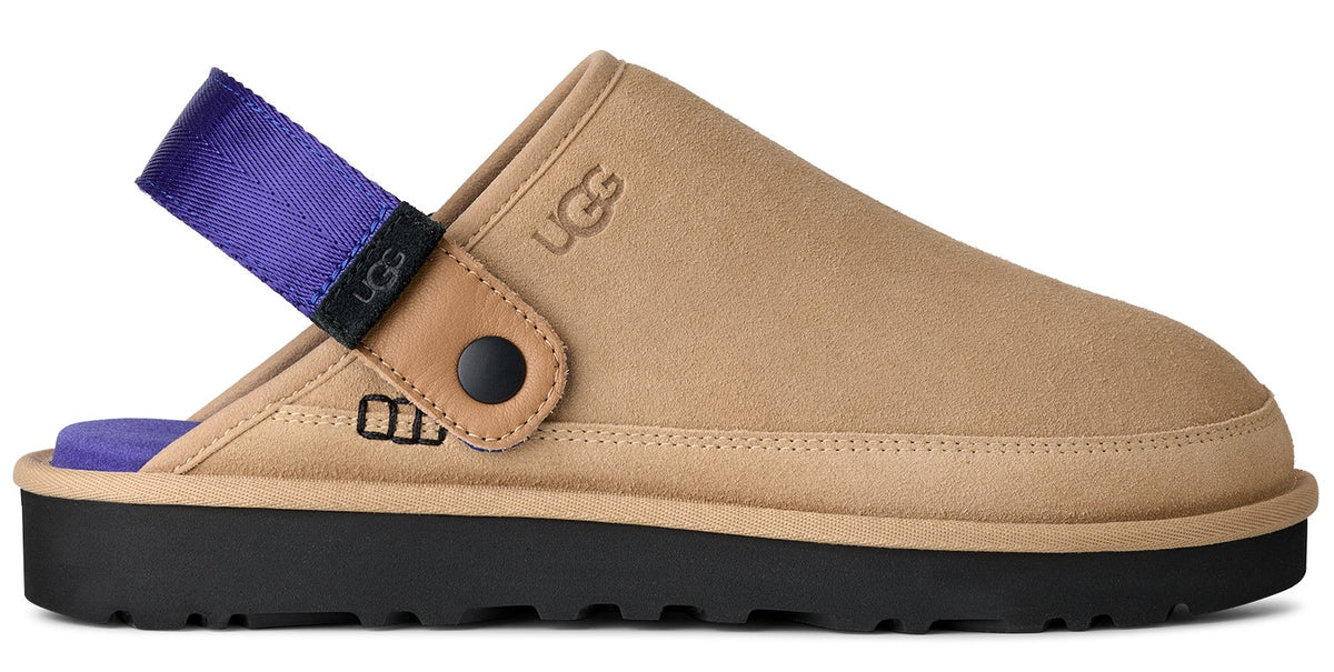 Tan clog with a black sole, and a purple fabric heel strap.
