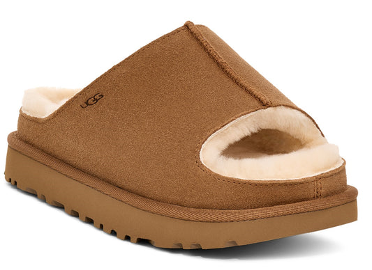 Open toed slipper with tan suede top and rubber sole, lined with light fur and UGG logo.